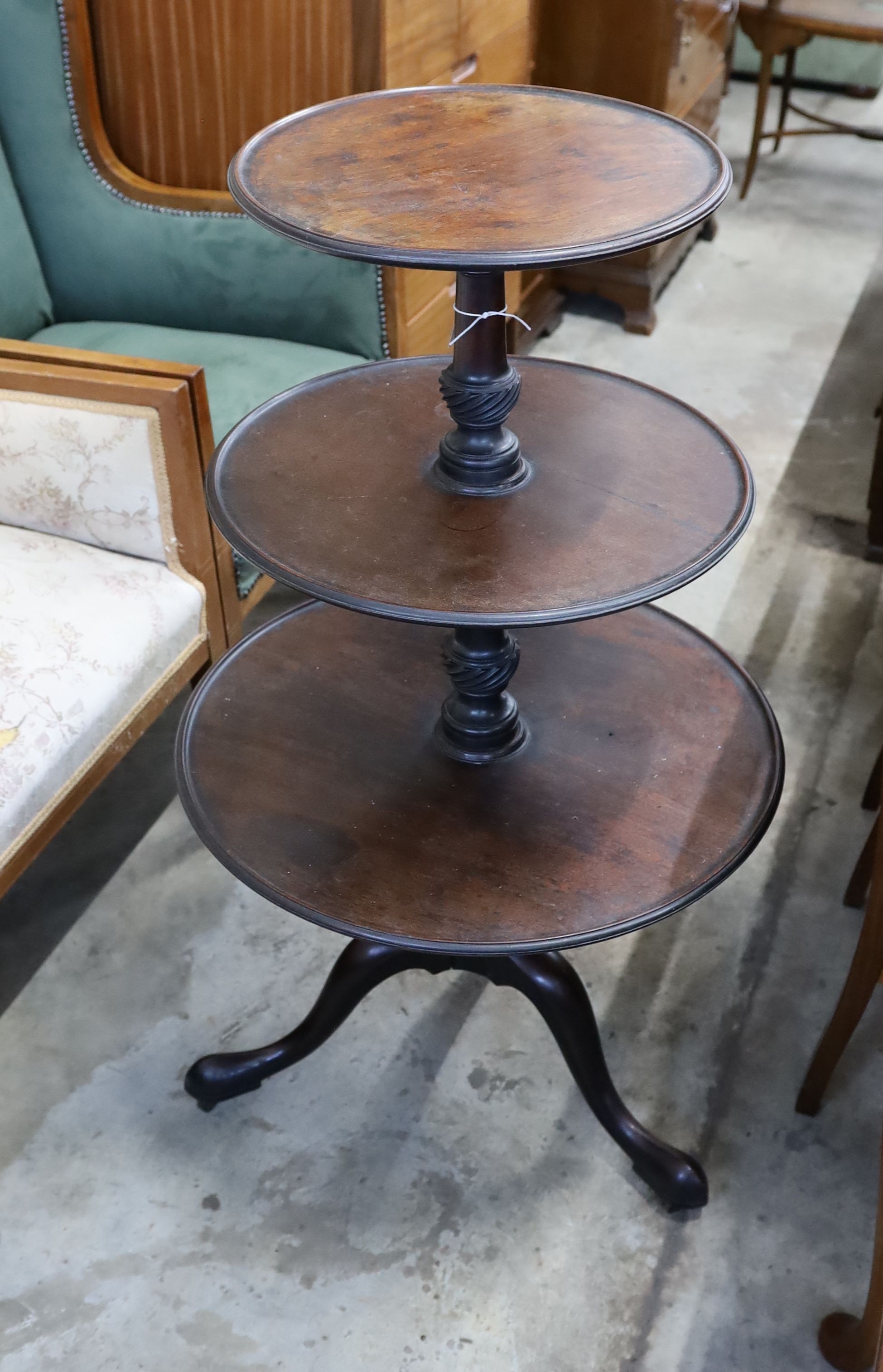 A George III circular mahogany three tier dumb waiter, diameter 60cm, height 106cm